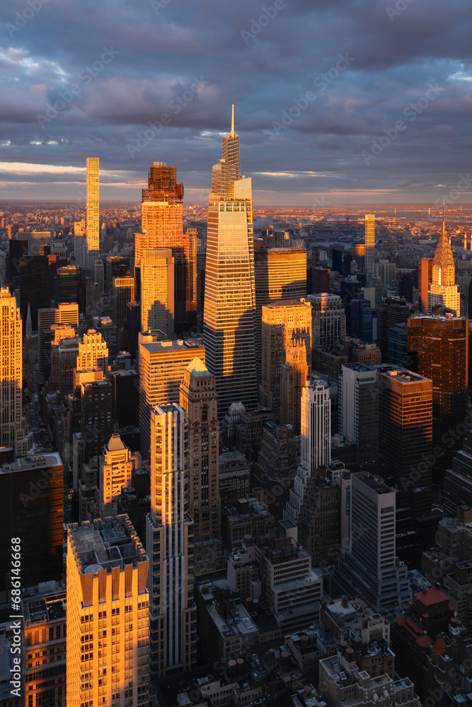 New York City aerial view of Midtown Manhattan skyscrapers and long shadows at sunset