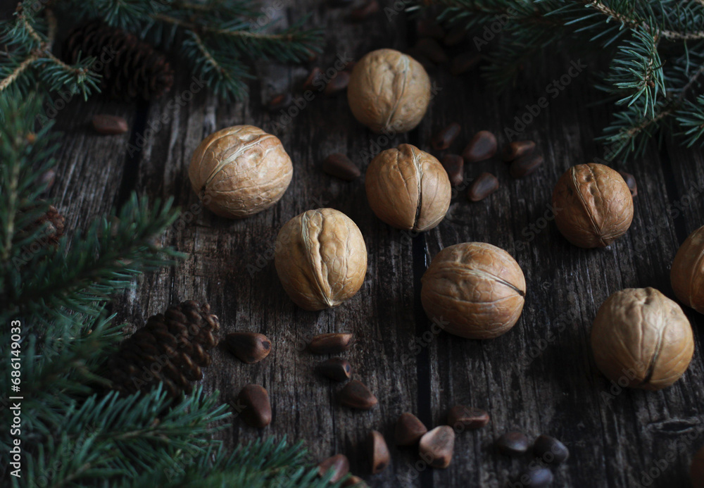 New Year's layout of spruce branches of pine and walnuts on a wooden background