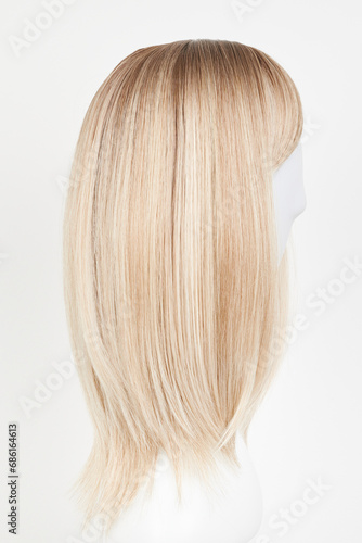 Wallpaper Mural Natural looking blonde fair wig on white mannequin head. Middle length hair cut on the plastic wig holder isolated on white background, side view. Torontodigital.ca