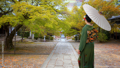 Young Japanese Woman in a Traditional Kimono Dress at Shinnyodotemple in Kyoto, Japan  photo