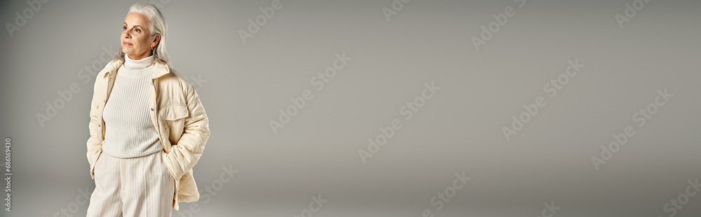 grey haired middle aged woman in trendy winter outfit posing with hands in pockets, banner grey haired middle aged woman in trendy winter outfit posing with hands in pockets, banner