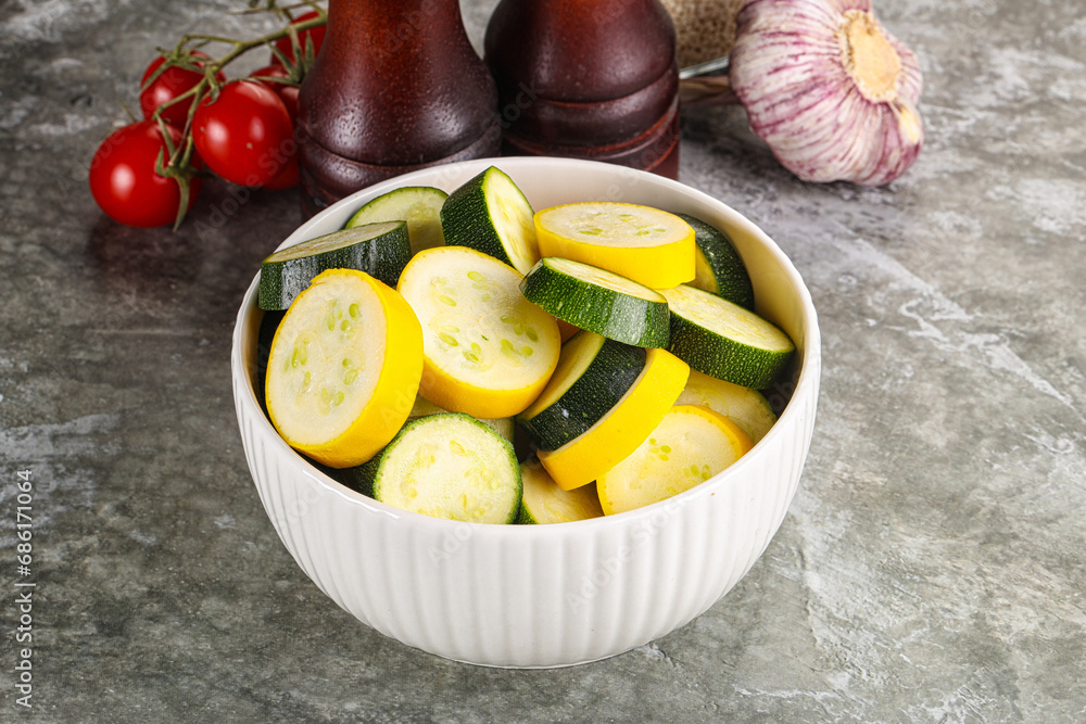 Sliced raw young green and yellow zucchini