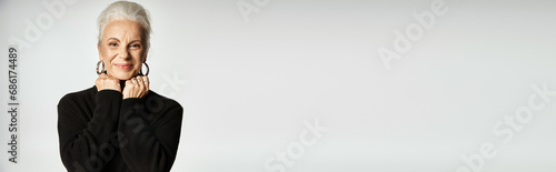 Fotografi happy middle aged business woman in elegant smart casual attire posing on grey b
