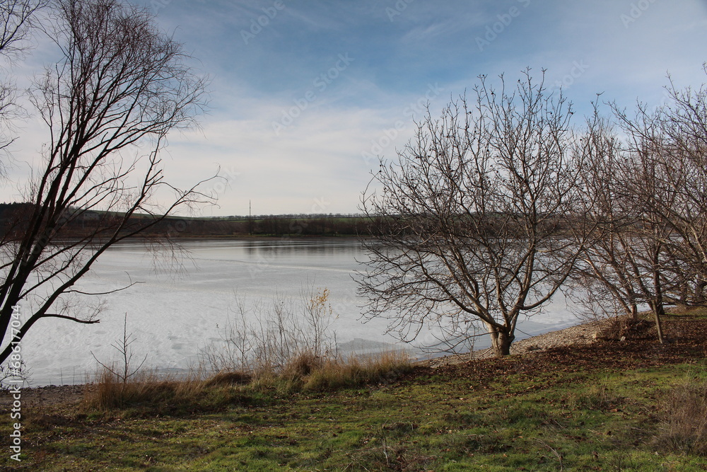 A body of water with trees around it A body of water with trees around it
