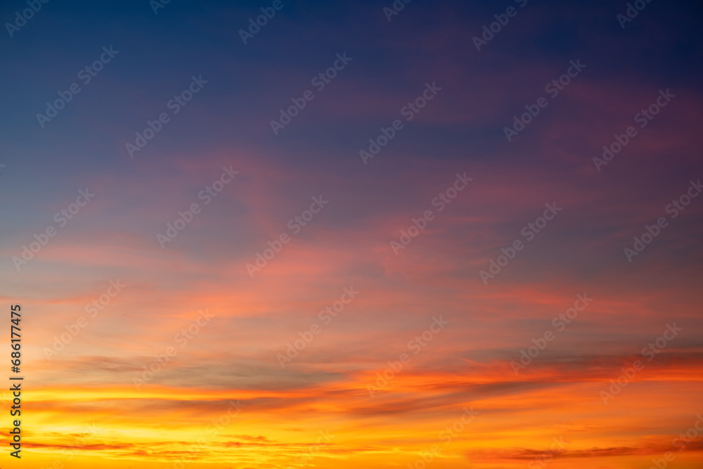 Beautiful of luxury soft gradient orange gold clouds and sunlight on the blue sky perfect for the background, take in everning,Twilight