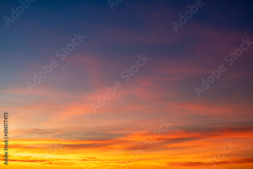 Beautiful of luxury soft gradient orange gold clouds and sunlight on the blue sky perfect for the background, take in everning,Twilight photo