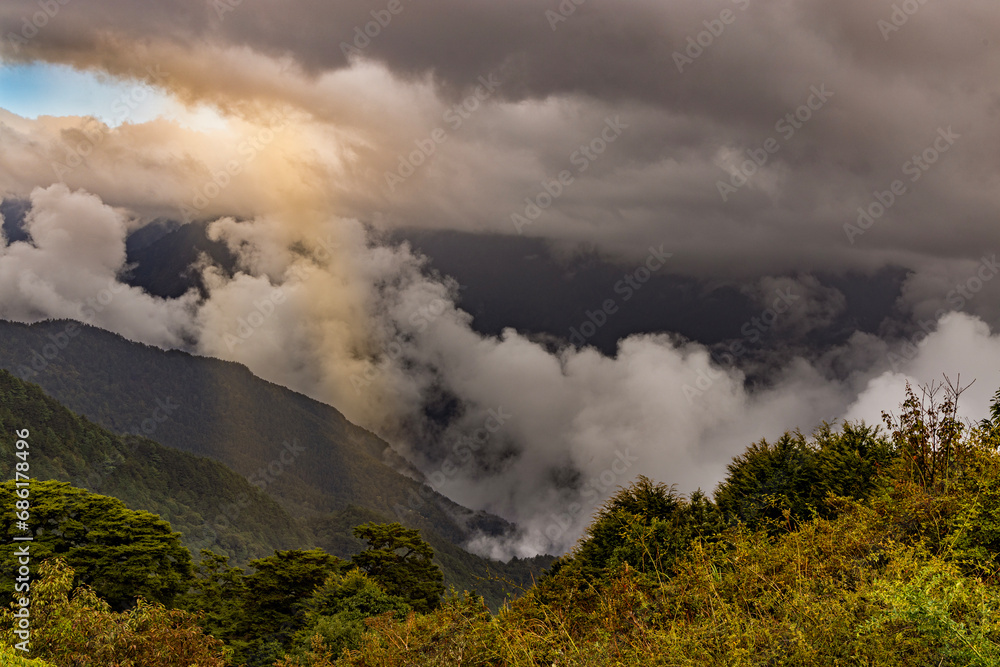 close up of the astonishing cloudscape.The surging,churning sea of cloud on the top of the green mountain,Jesus light and cloudy sky form a scenic scenery view.High quality photo,Hehuanshan,Taiwn.