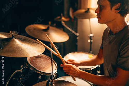 Photography Drummer plays drums in music studio at band rehearsal
