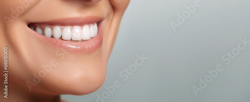 Smile of beautiful middle aged mature woman with perfect white teeth close-up. Dental care concept, professional cleaning, whitening. Dentistry, beautiful smile