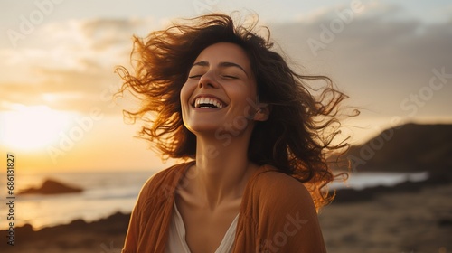 Portrait of calm happy smiling free woman with open arms and closed eyes enjoys a beautiful moment life on the seashore at sunset time #686181827