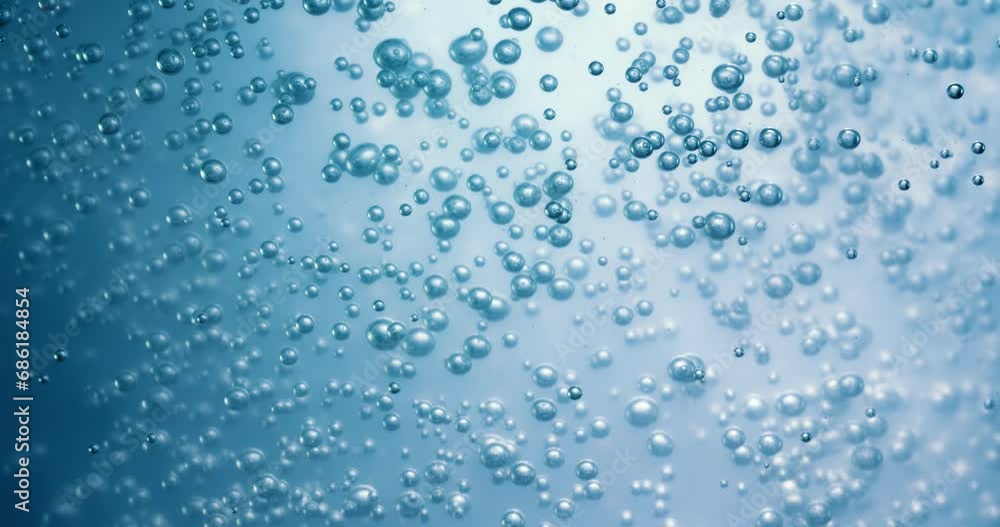 Many water bubbles in blue water close up, abstract water wave with bubbles in slow motion. Many water bubbles in blue water close up, abstract water wave with bubbles in slow motion.