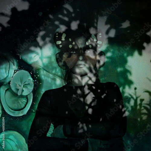 Beauty, fine-art, pop-art, fashion concept. Beautiful woman with butterfly or moth mask portrait standing in shade. Green grunge surreal background. Tree foliage shadow casting on model