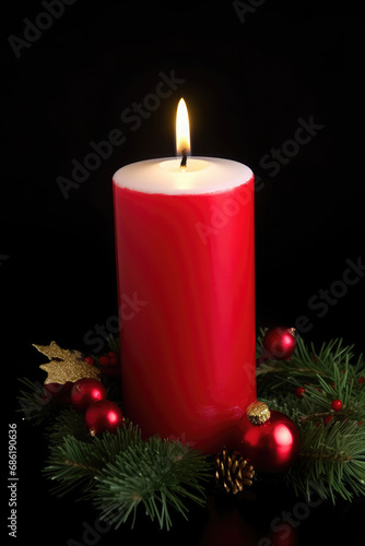 Red christmas candle and christmas decorations on a dark background 