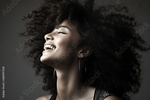 Portrait of a happy laughing African American woman with curly afro hairstyle © Sergio