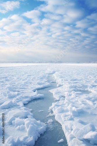 Blue clouds and frozen water. Winter landscape. Snow covered ground.