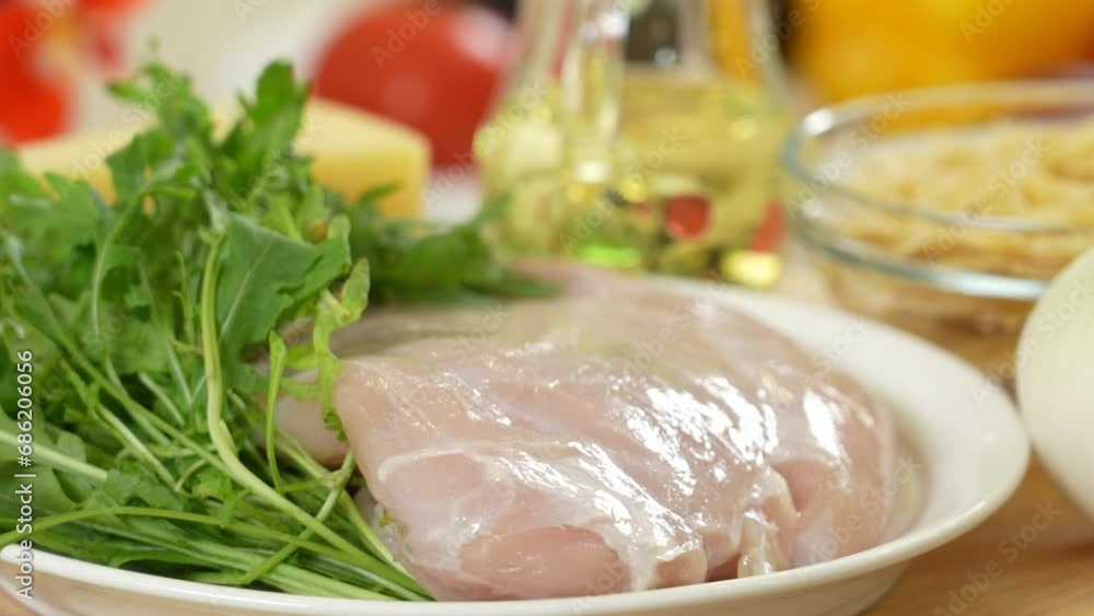 Raw turkey fillet on a plate among other ingredients Raw turkey fillet on a plate among other ingredients