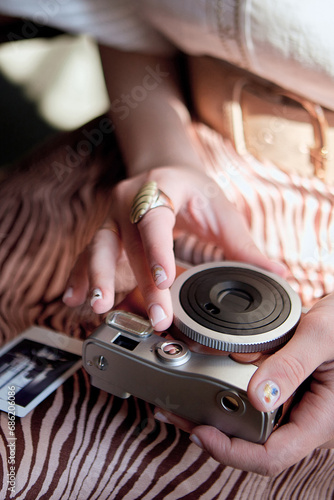Close view of a girl holding a retro camera