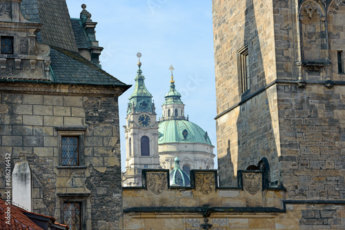 Photography Saint Nicholas Cathedral between towers of Charles Bridge in Prague