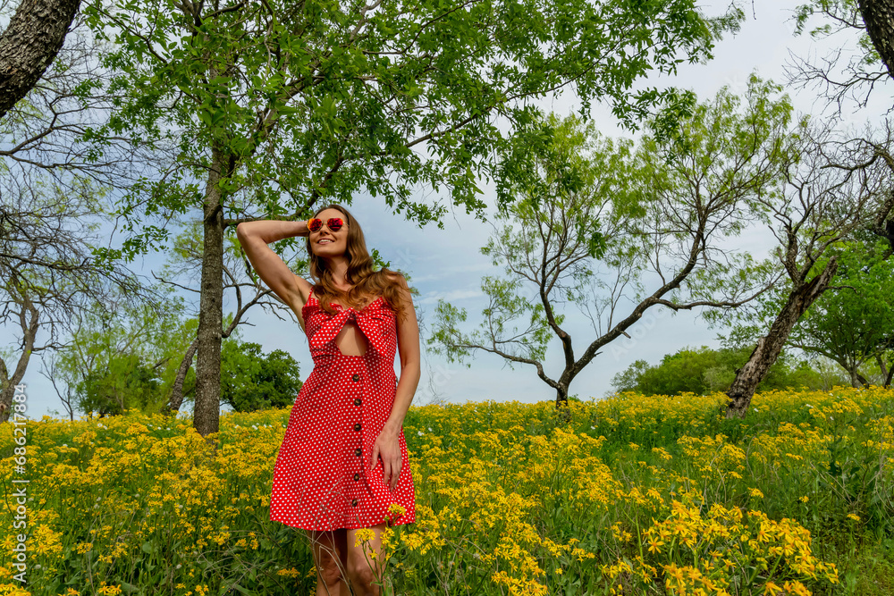 A Lovely Brunette Model Poses In A Field Of Yellow Flowers In A Texas Prarie