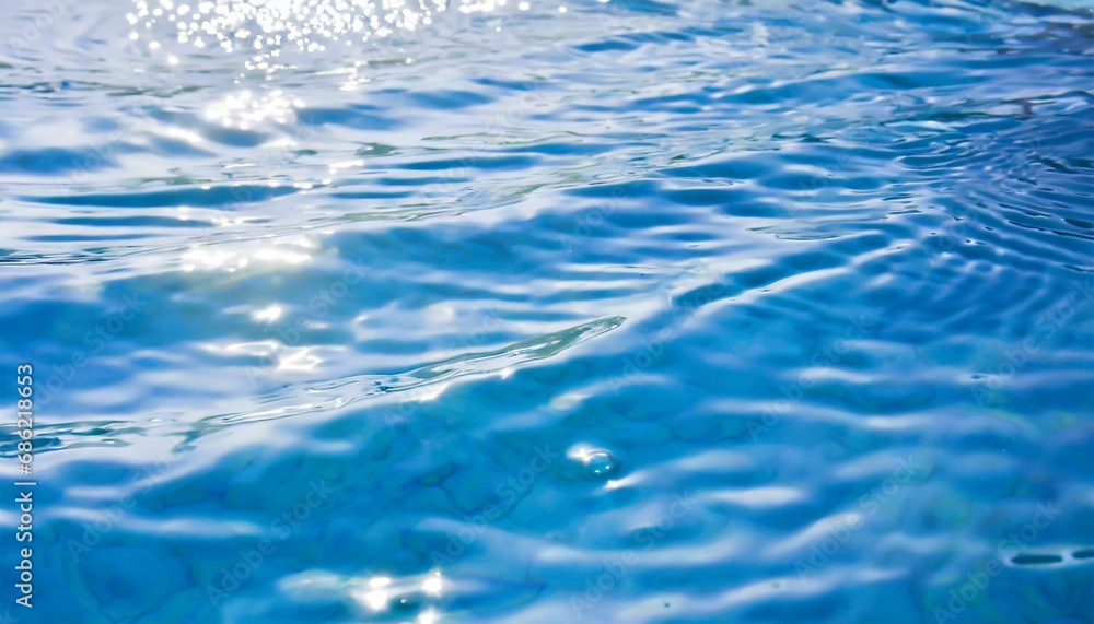 blue water with ripples on the surface defocus blurred blue colored clear calm water surface texture with splashes and bubbles water waves with shining pattern texture background