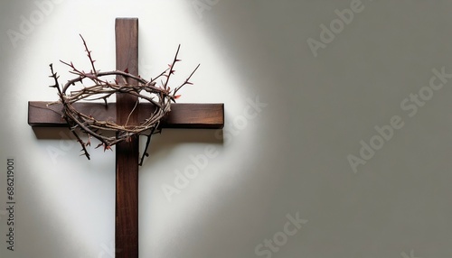 symbolic wooden cross with thorns crown on white background representing lent easter holy week passion with space for text photo