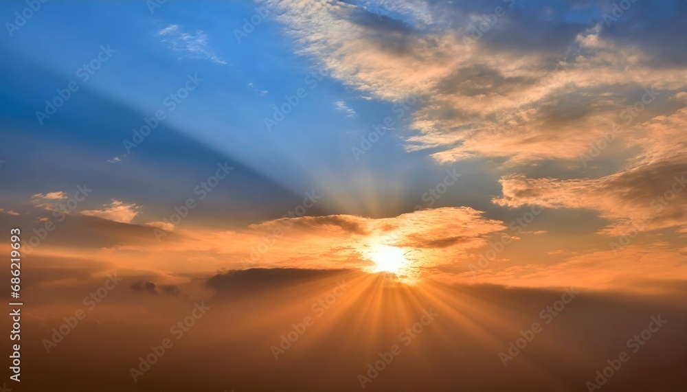 sun rays on sunset sky with blue ond orange colorful sunset clouds