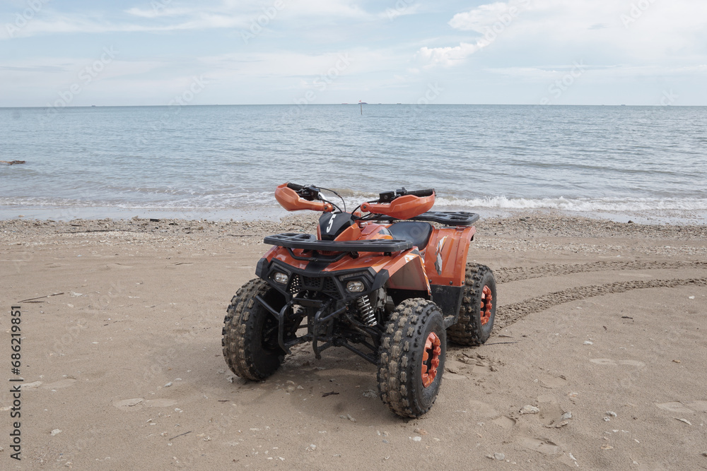ATV Parked at seashore on clean  beach with beautiful skies