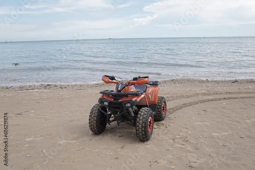 ATV Parked at seashore on clean beach with beautiful skies