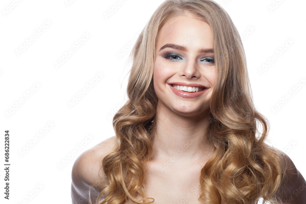 Smiling young female model portrait. Blonde woman with long wavy hair, makeup and clean skin on white background Smiling young female model portrait. Blonde woman with long wavy hair, makeup and clean skin on white background