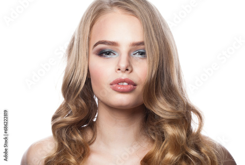 Nice young female model portrait. Blonde woman with long wavy hair, makeup and clean skin on white background