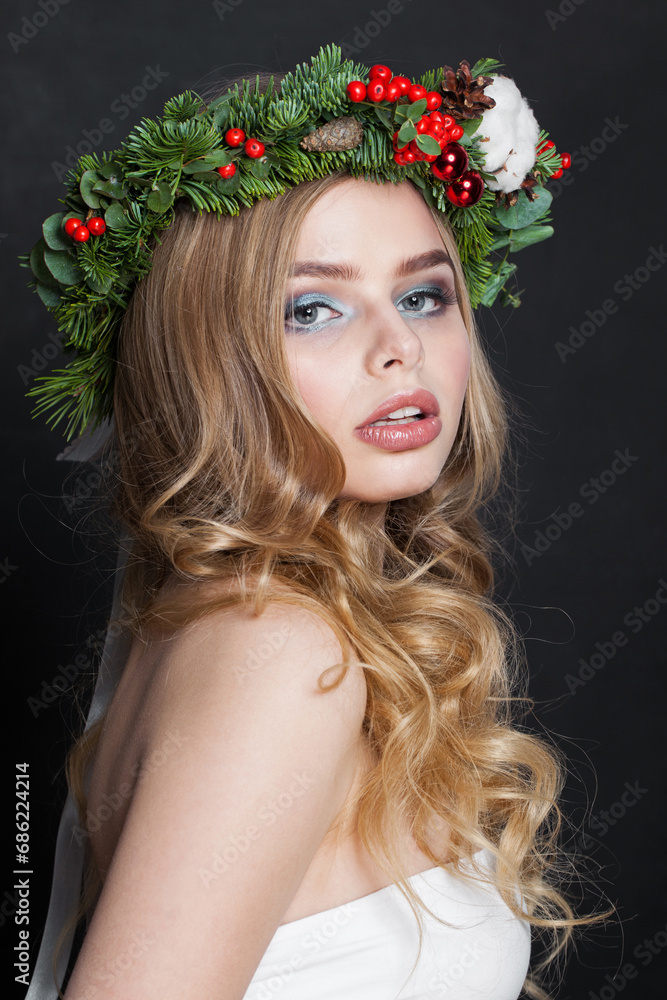Naklejka premium Christmas beauty woman. Gorgeous model with makeup, clean fresh skin, wavy blonde hair, perfect smile and Xmas New Year decoration