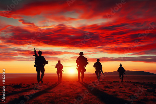 Military silhouettes on sunset sky background. Military silhouettes of soldiers against the backdrop of sunset sky.