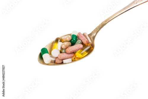 Vitamins and supplements. A variety of vitamin tablets in wooden spoons isolated on a white background. Multivitamin complex for every day. Nutritional supplements.Copy space.Vitamins for immunity
