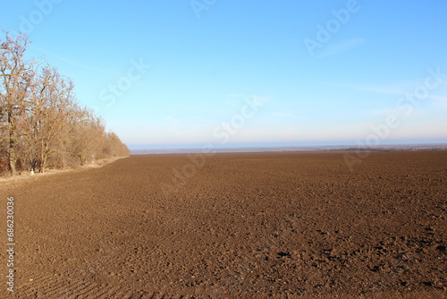 Plowed agricultural field with traces of agricultural machinery © Alex Milan