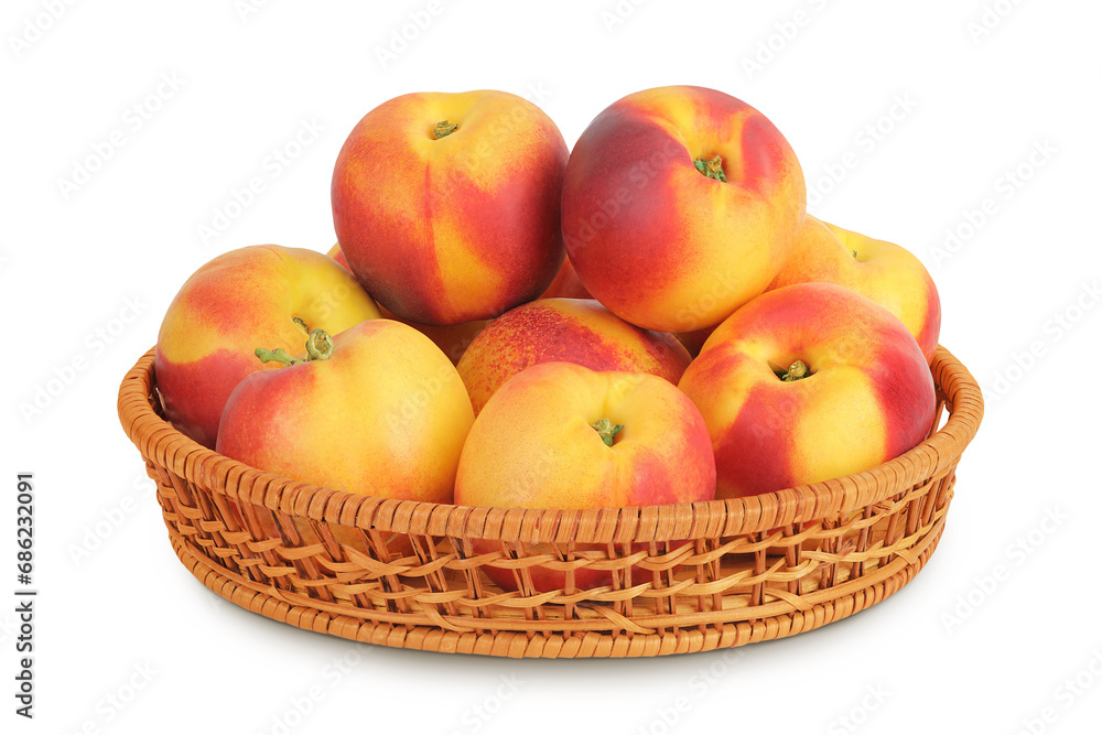 Ripe nectarine fruit in a wicker basket isolated on white background with full depth of field Ripe nectarine fruit in a wicker basket isolated on white background with full depth of field