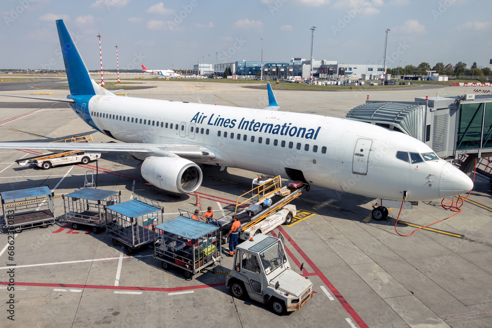 An airplane with the fictitious name of the airline is standing on the runway An airplane with the fictitious name of the airline is standing on the runway