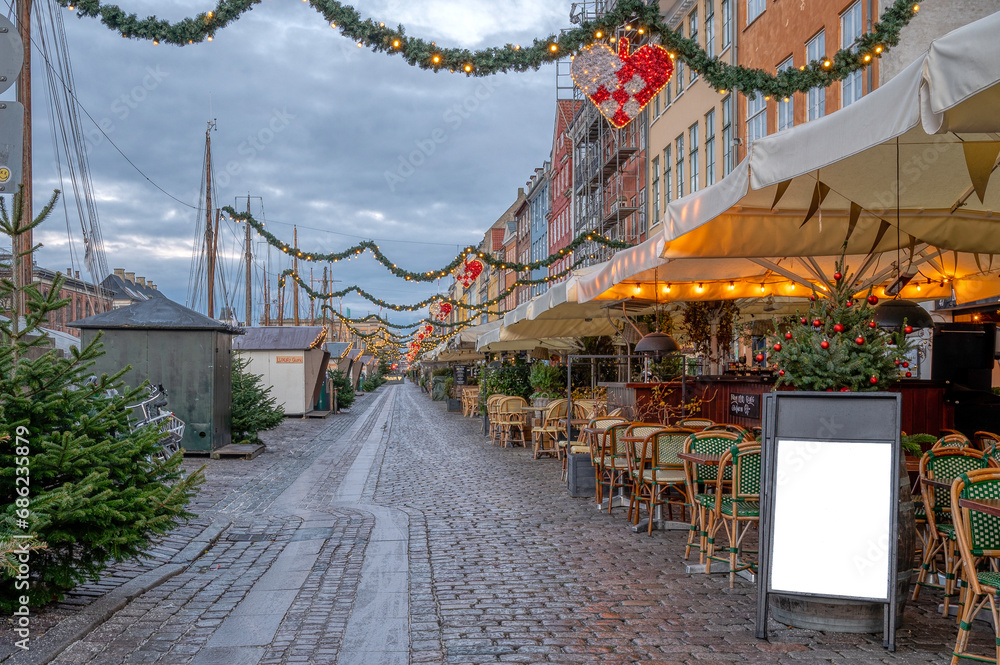 Christmas decorations along the Nyhamns Canal with a white signboard