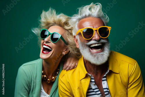 Happy Couple of mature people in sunglasses enjoying and having fun in vacations on green background. summer. Travel and travelers lifestyle. Retirement age. photo