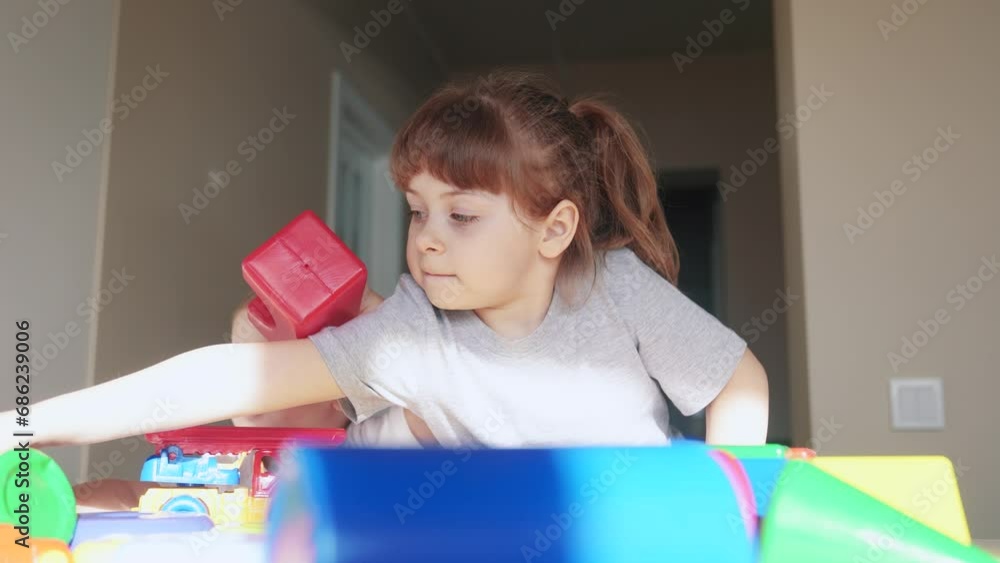 kids girl and baby play in kindergarten. a group of children play indoor toys cubes and cars on the table in kindergarten. happy family preschool education concept. nursery baby toddler home kids girl and baby play in kindergarten. a group of children play indoor toys cubes and cars on the table in kindergarten. happy family preschool education concept. nursery baby toddler home