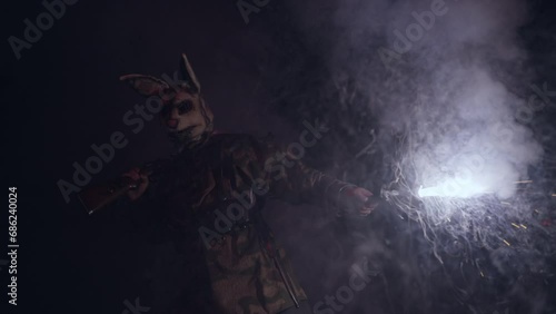 
A terrorist in a scary mask holds a lit flare. scary moment