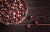 roasted chestnuts, in a wooden plate, top view, homemade, no people,