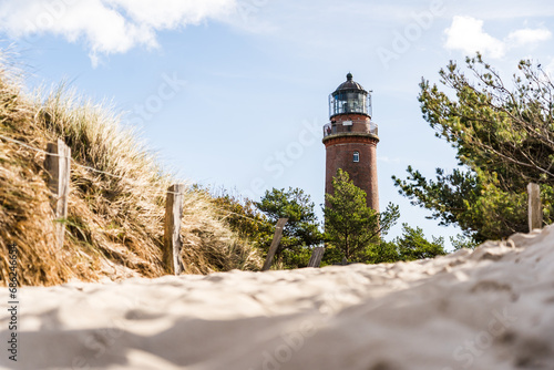 Fototapeta Naklejka Na Ścianę i Meble -  Lighthouse of Darsser Ort on German peninsula Darss with beach access in the foreground on a sunny day in autumn