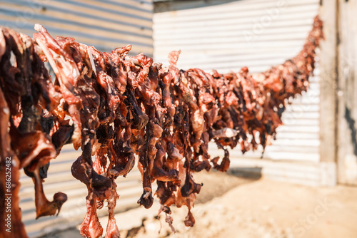 Strips of beef heads being dried for the consumption of local people, Katutura township, Windhoek, Namibia. These dried strips are difficult to digest and therefore provide long-lasting satiation. photo