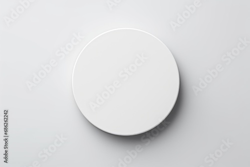 top view of white badge float on white background. Glossy round button.
