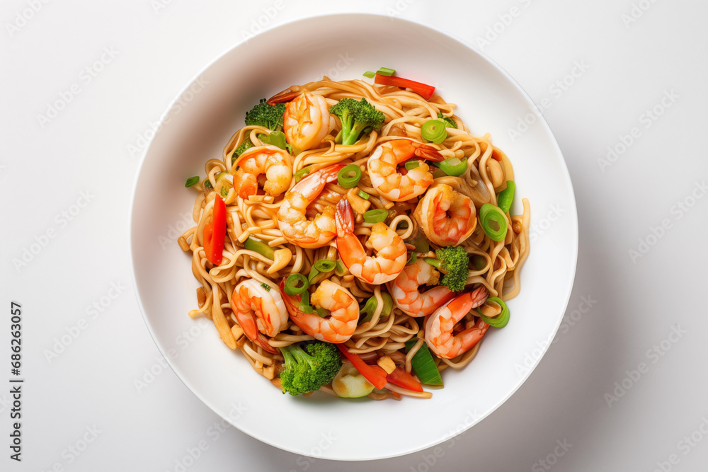 View from above on stir fry noodles, pepper, broccoli, and prawns unite in a sleek white bowl View from above on stir fry noodles, pepper, broccoli, and prawns unite in a sleek white bowl