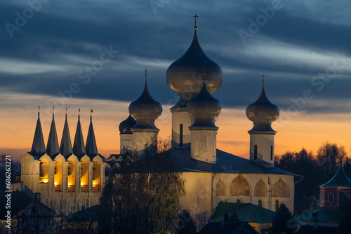 Belfry and domes of the Assumption Cathedral of the Tikhvinsky Assumption Monastery on a cloudy October evening. Tikhvin, Russia photo