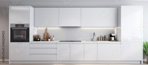 Modern kitchen with white cabinets built in cooker and microwave oven