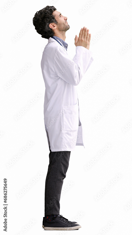 male doctor in a white coat on a white background in profile with his hands folded together male doctor in a white coat on a white background in profile with his hands folded together