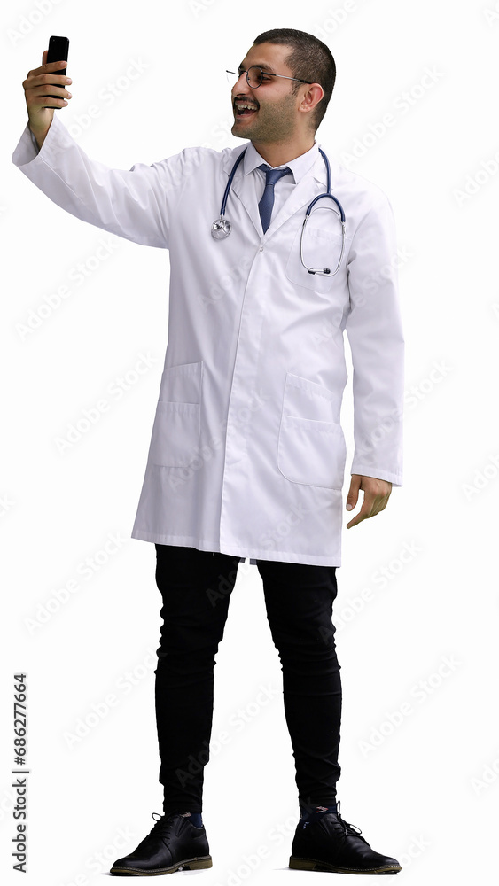 male doctor in a white coat on a white background looking at the phone