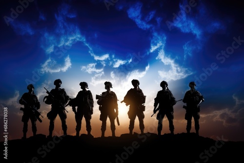 A group of soldiers standing on top of a hill. This image can be used to depict teamwork, leadership, or military themes.